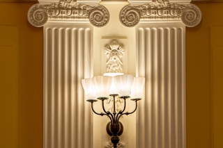 A closeup of pilasters and sconces in the Presidents' Room