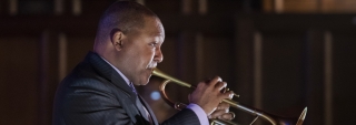 A high resolution, side-view closeup of Wynton Marsalis playing the trumpet