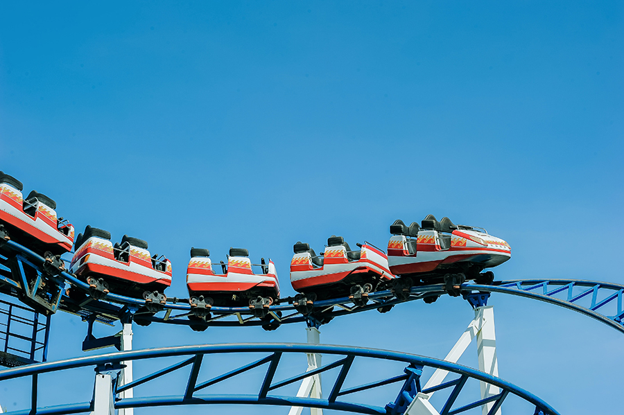 Red and white roller coaster on railings by Min An from Pexels