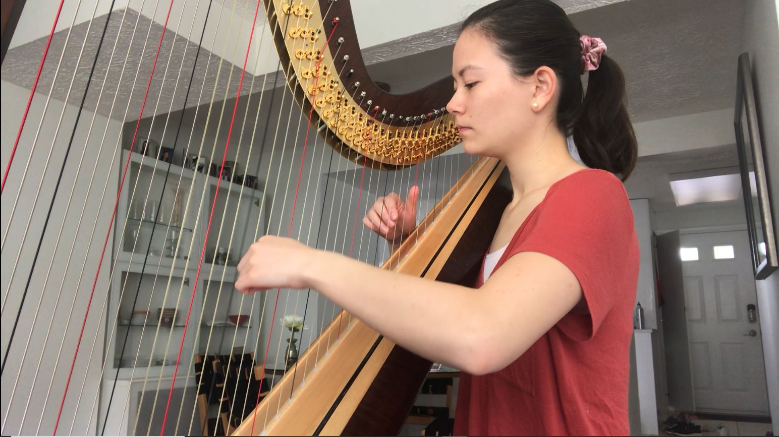Kai-Lan Olson playing a harp