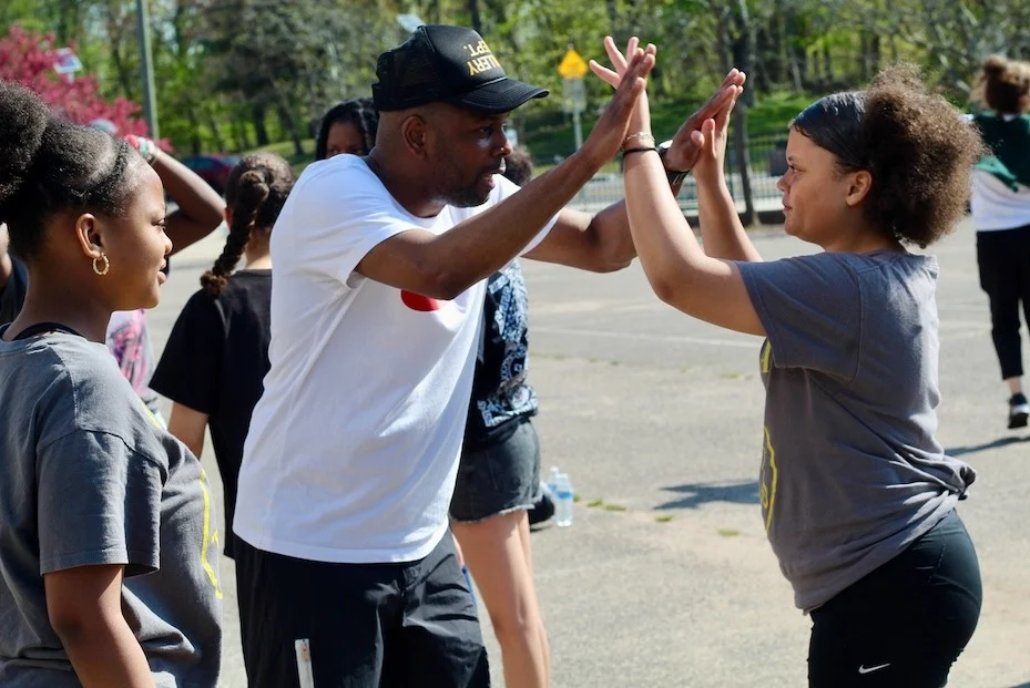 People out in the sunshine dancine.