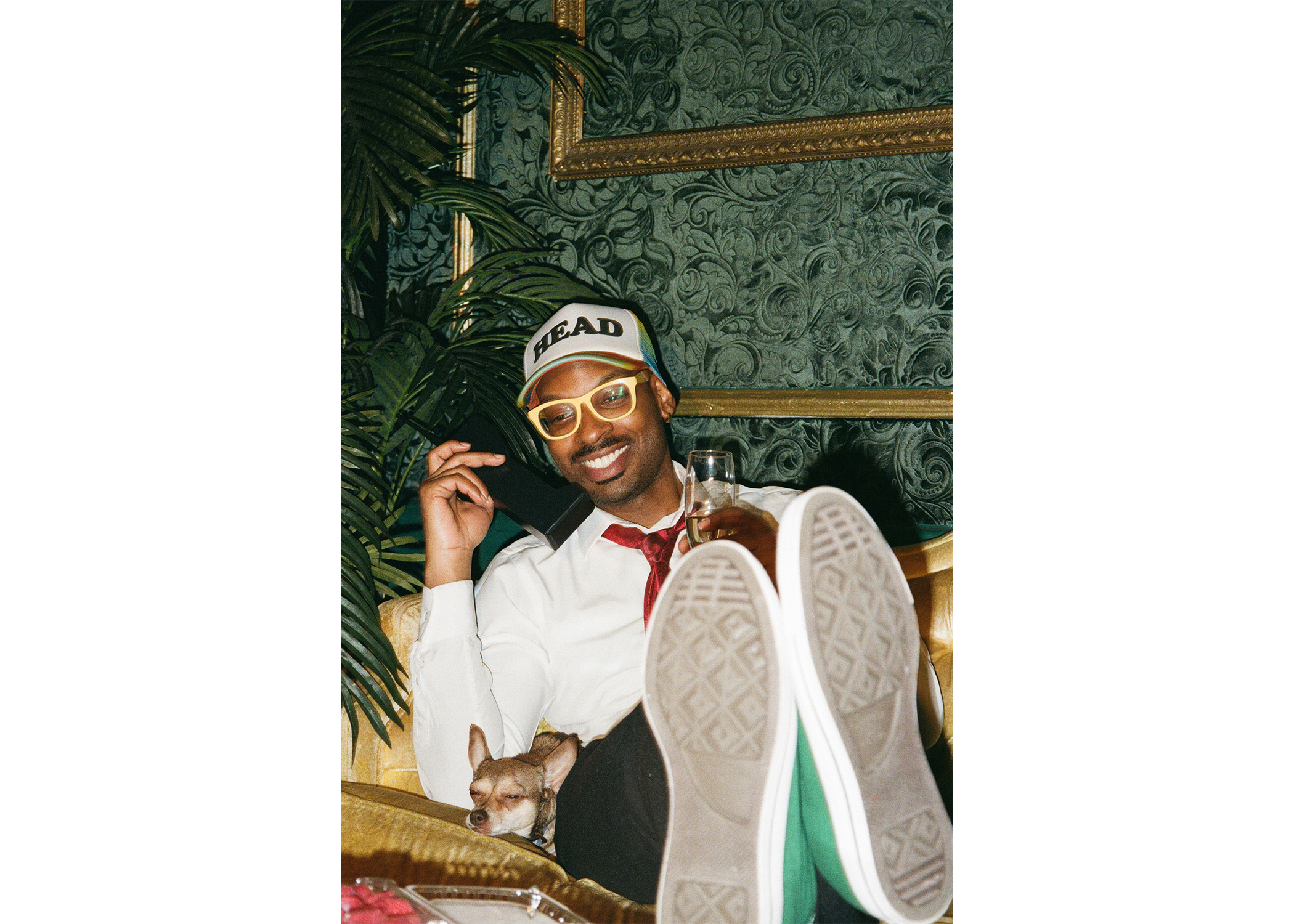 Smiling with feet on table.
