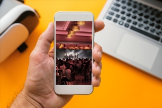 Hand holding a smartphone with a rendering of The Underground on the screen