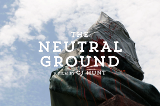 Screen grab from 'The Neutral Ground' movie trailer showing the movie's title superimposed over image of a sheet covering the head of a statue