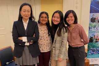 Min Jin Lee Stands next to three students in the Presidents' Room at YSC