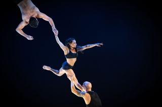 Acrobatic mid air move with three people.