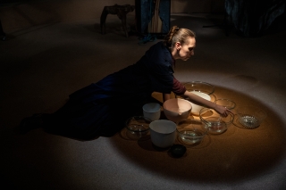 Woman sitting on the floor surrounded by bowls