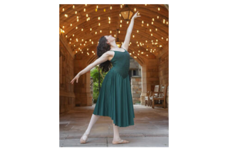 Woman in green dress in balet pose.