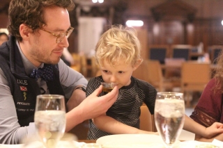 Four-year-old Axel giving Italian olive oil a smell with dad, Joseph Luchsinger, at his right.