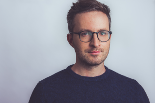 Headshot with eyeglasses.