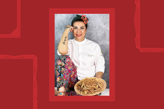 Chef dressed in colorful pants and white top. Sitting holding a plate of wheat.