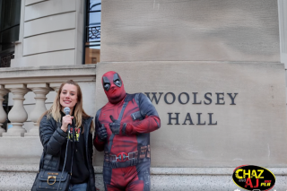 Man in a Deadpool costume being interviewed in front of Woolsey Hall.