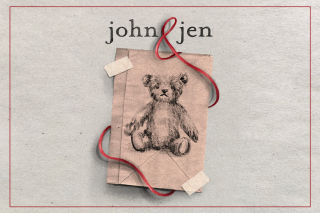 John &amp; Jen title. &amp; is made with a red ribbon that wraps around a brown paper bad. On the bag is a drawing of a teddy bear.