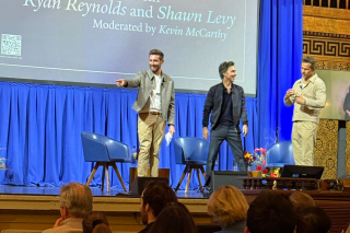 Three people on stage. 