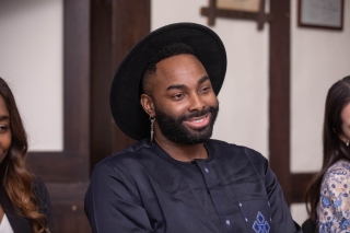 Headshot. Houngan Collin Edouard wearing a hat and smiling.