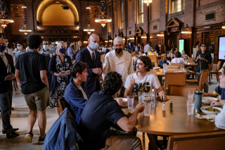Yale President Peter Salovey chats with a group of students and staff at lunch in Commons