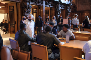 Yale President Peter Salovey chats with a group of students at lunch in Commons