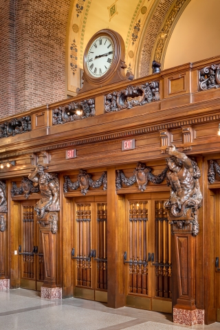 Adorned with intricate wooden relief carvings, these doors lead to Commons from the Memorial Rotunda. Photo by Francis Dzikowski.