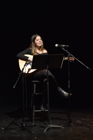 Student playing guitar and singing at 2019 LatinXcellence Showcase
