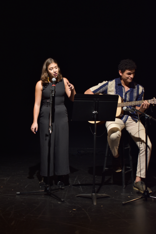 One student singing while another plays the guitar at 2019 LatinXcellence Showcase