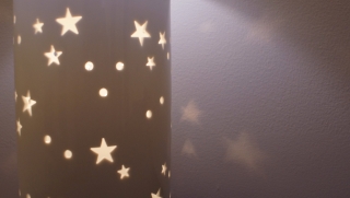 Stars lit on wall projecting from lamp.