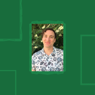 Headshot in front of greenery.