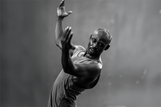 Black and white image, mid dance move.
